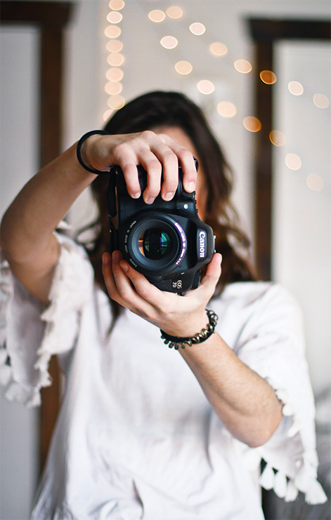 A content creator is seen taking a vertical photo of the viewer